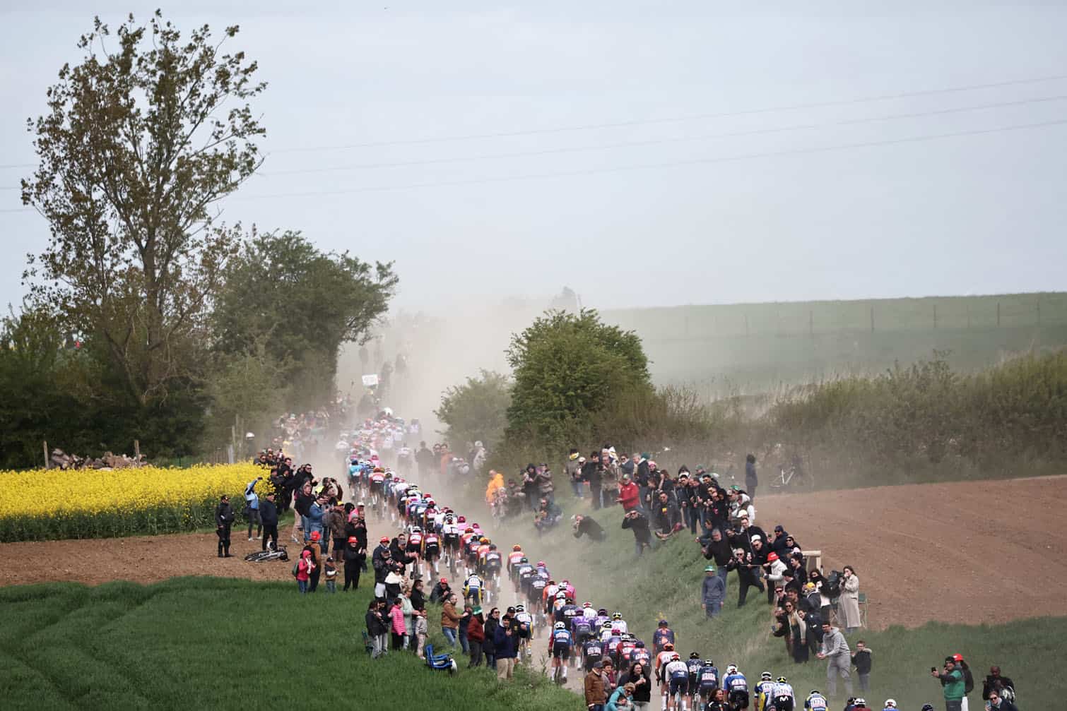 The pack rides on the first cobblestone sector of "Troisville"