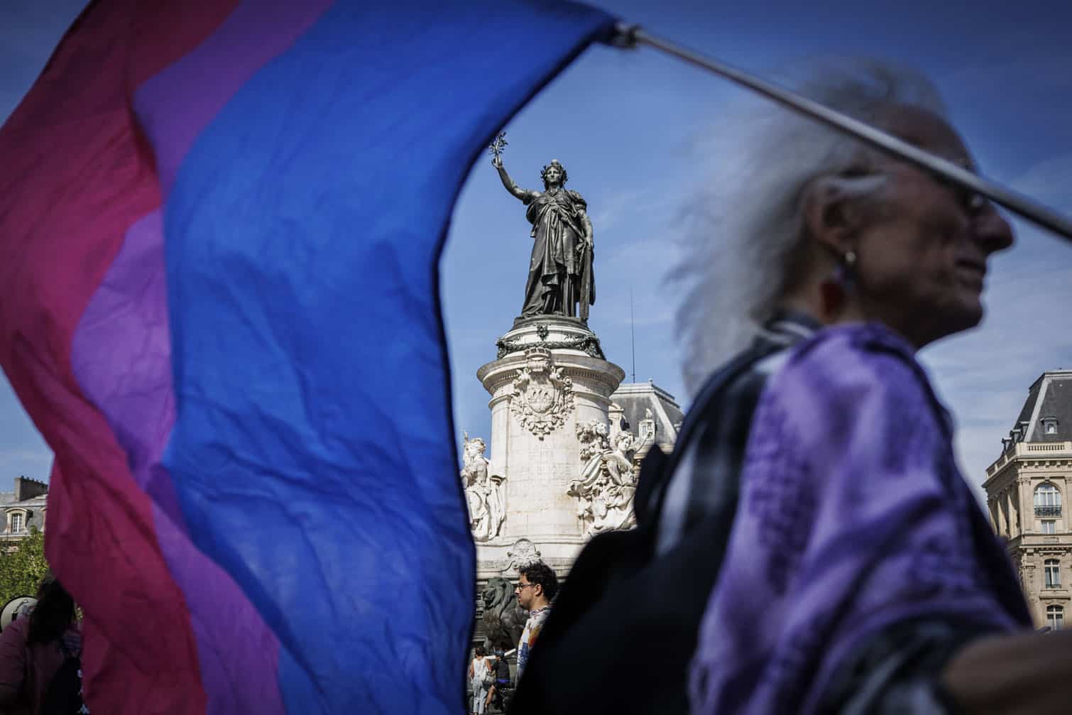 A protester holds a lesbian pride flag