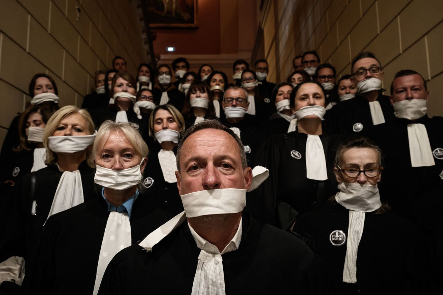 Lawyers gather with their mouths taped shut