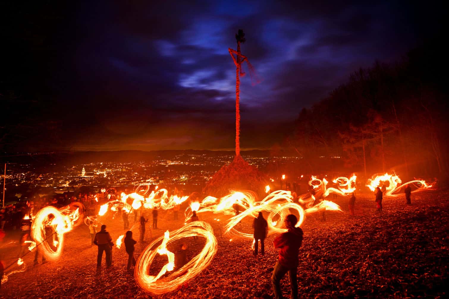 Participants wave burning torches