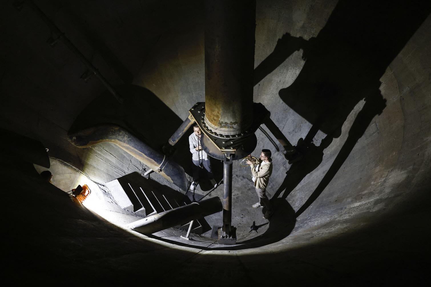 Brass musicians play music in an empty and cleaned anaerobic digester