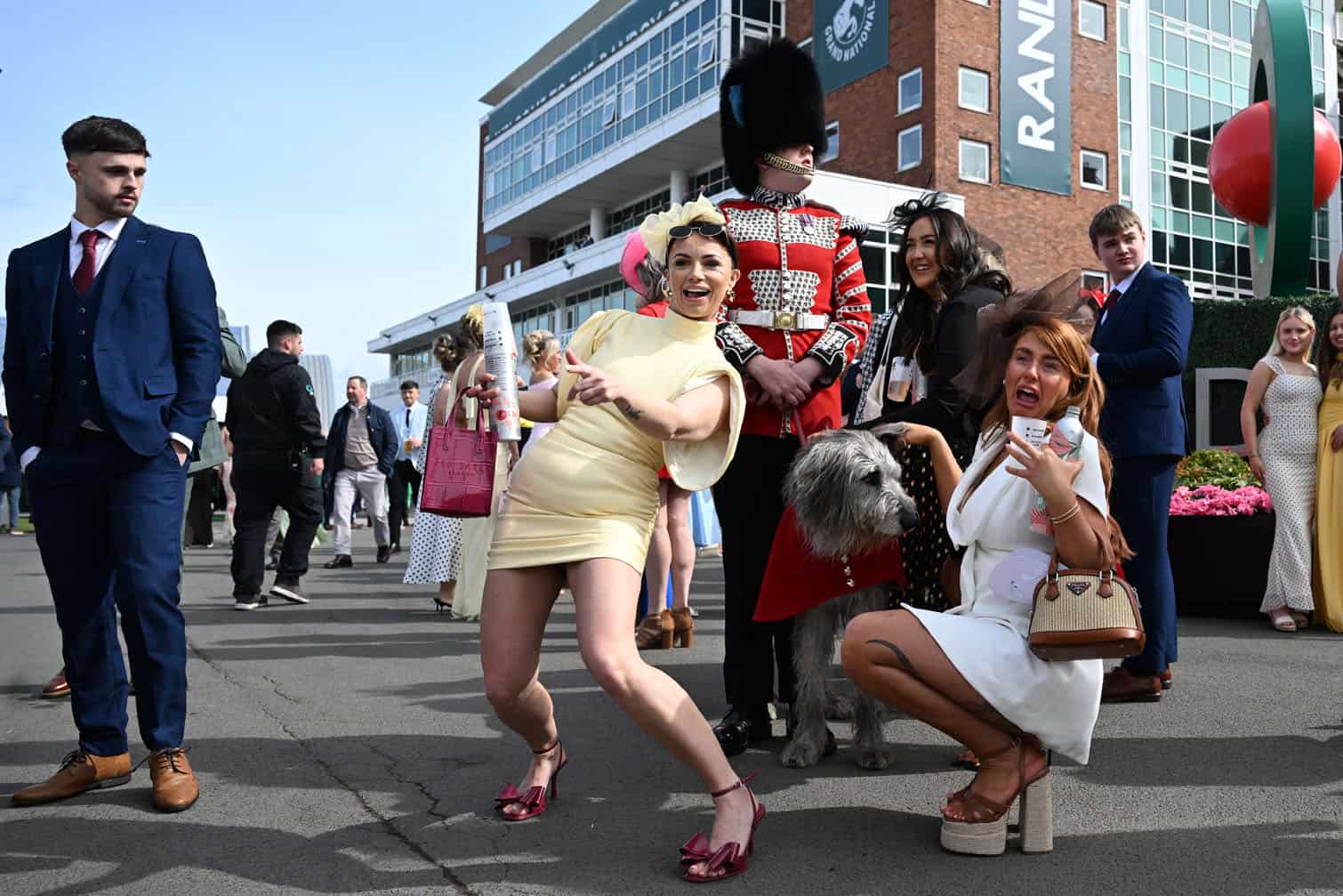 Racegoers pose for a picture with Irish Guards' mascot "Seamus"