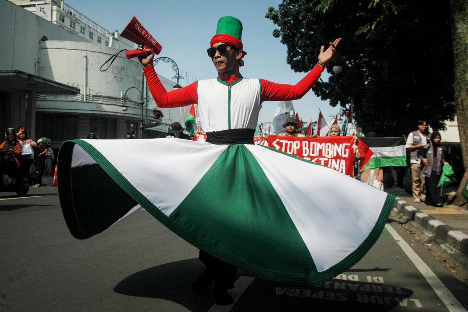 A Sufi dancer joins a rally in support of Palestine