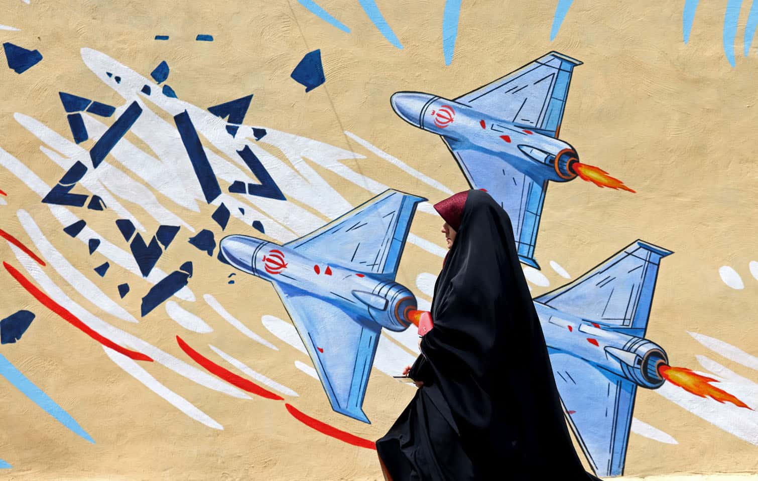 A woman walks past an anti-USA