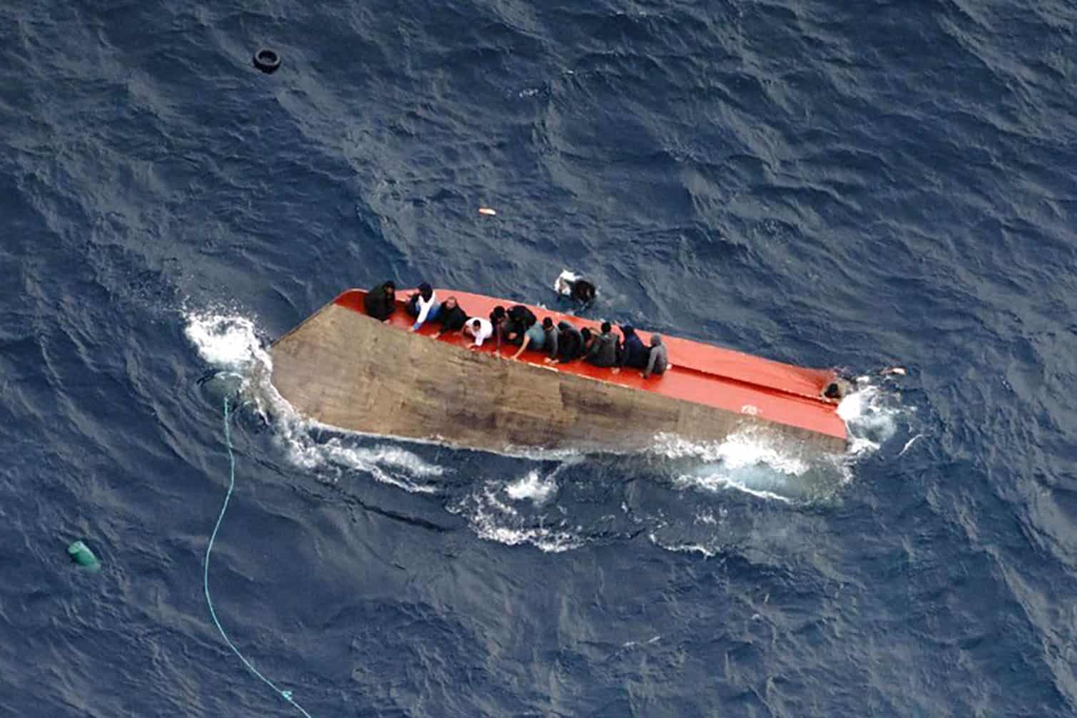 migrants seatted on a capsized boat off Libya