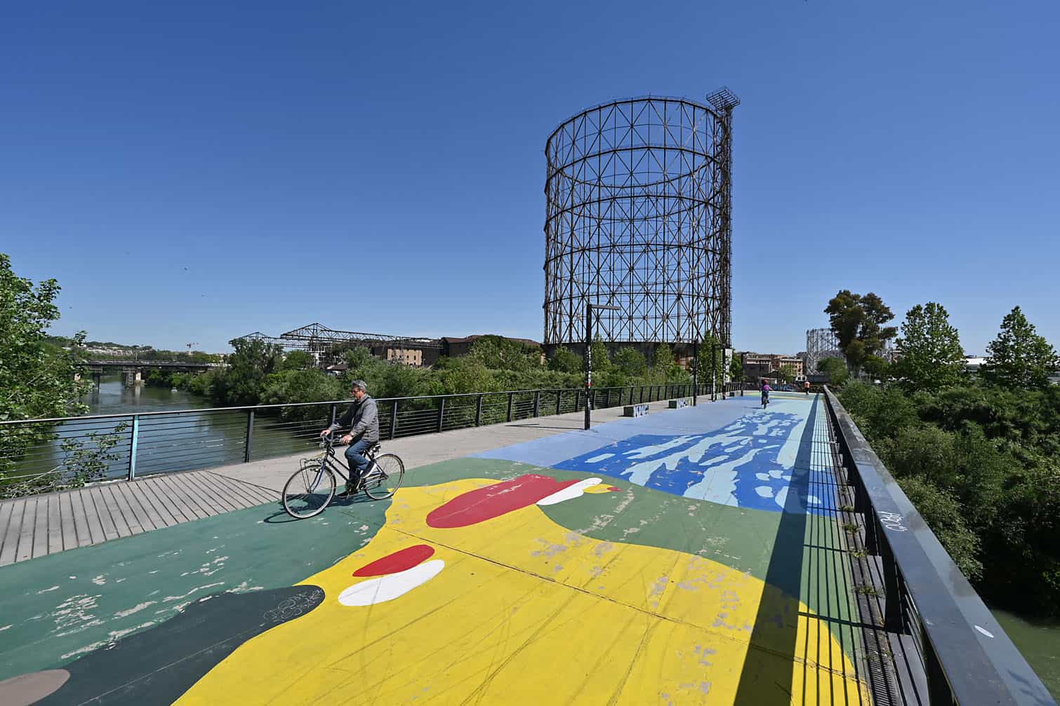 A cyclist rides near the Gazometro