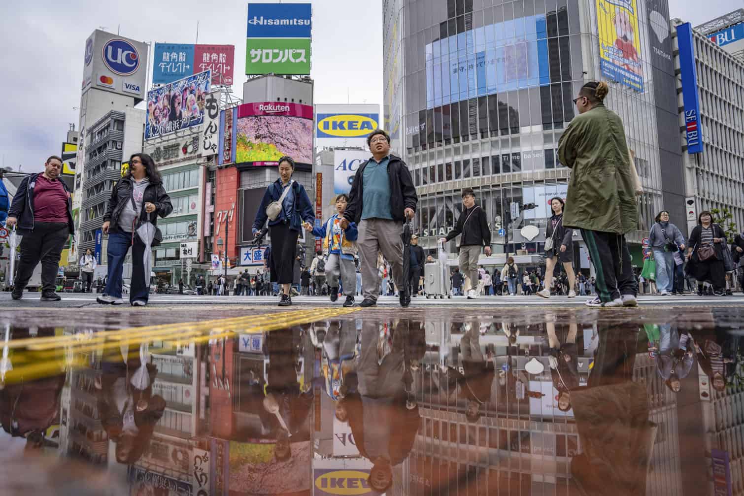 People cross the Shibuya Crossing