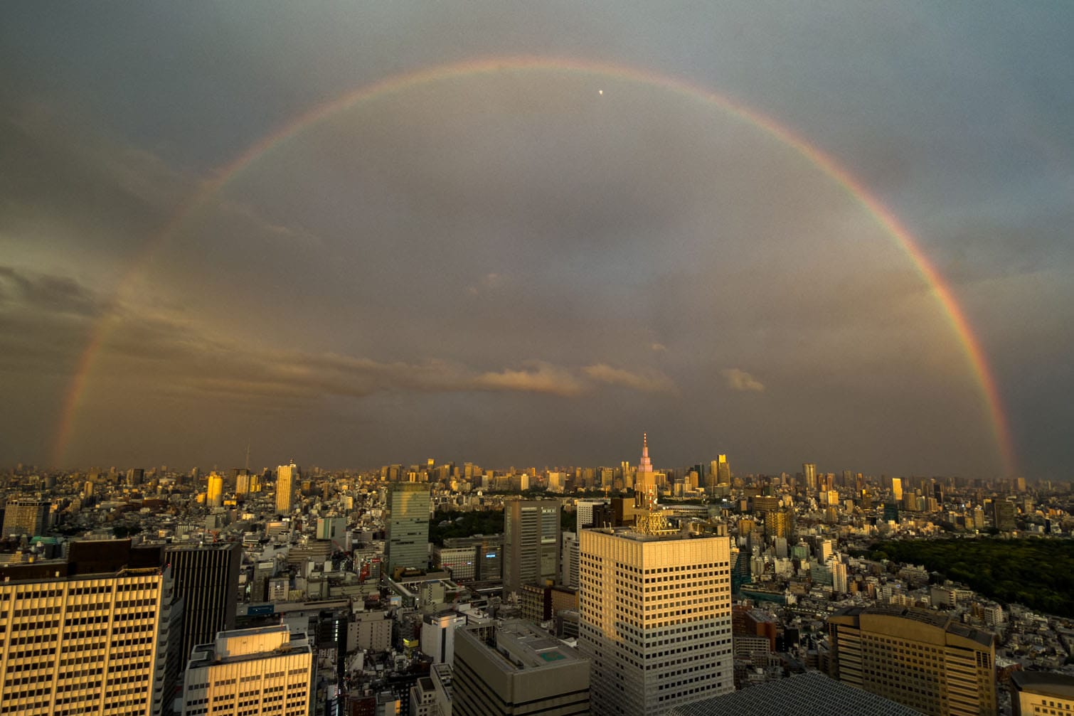 A general view shows the city skyline and a rainbow