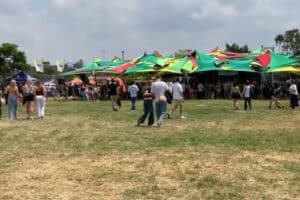 Crowds gather under stretch tents at an outdoor event at Menlyn Centre.