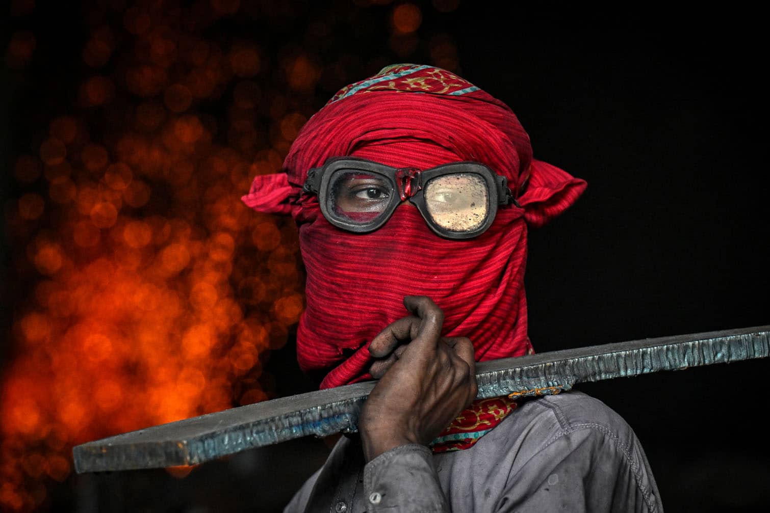 A labourer works at an iron factory