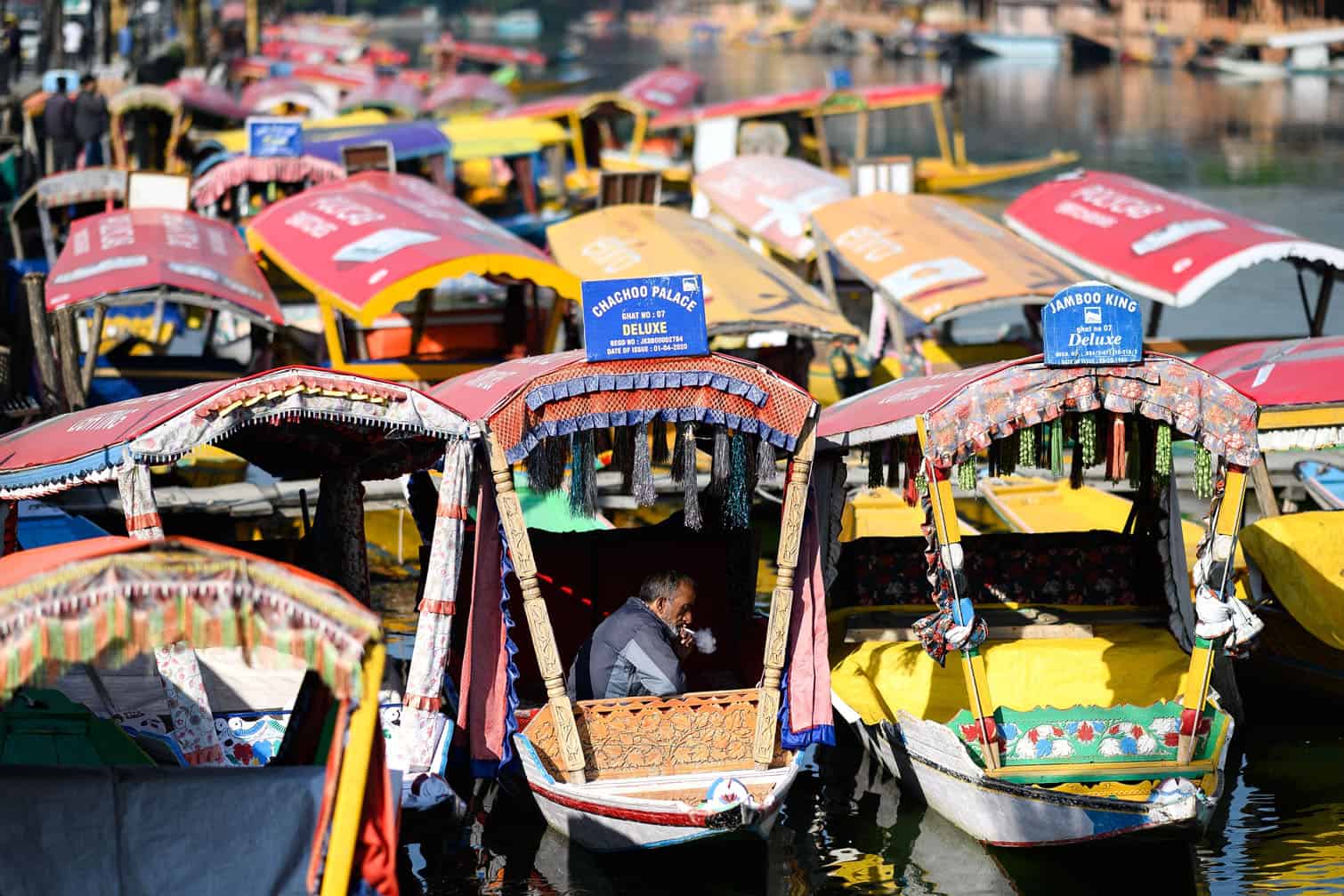 A boatman smokes a cigarette