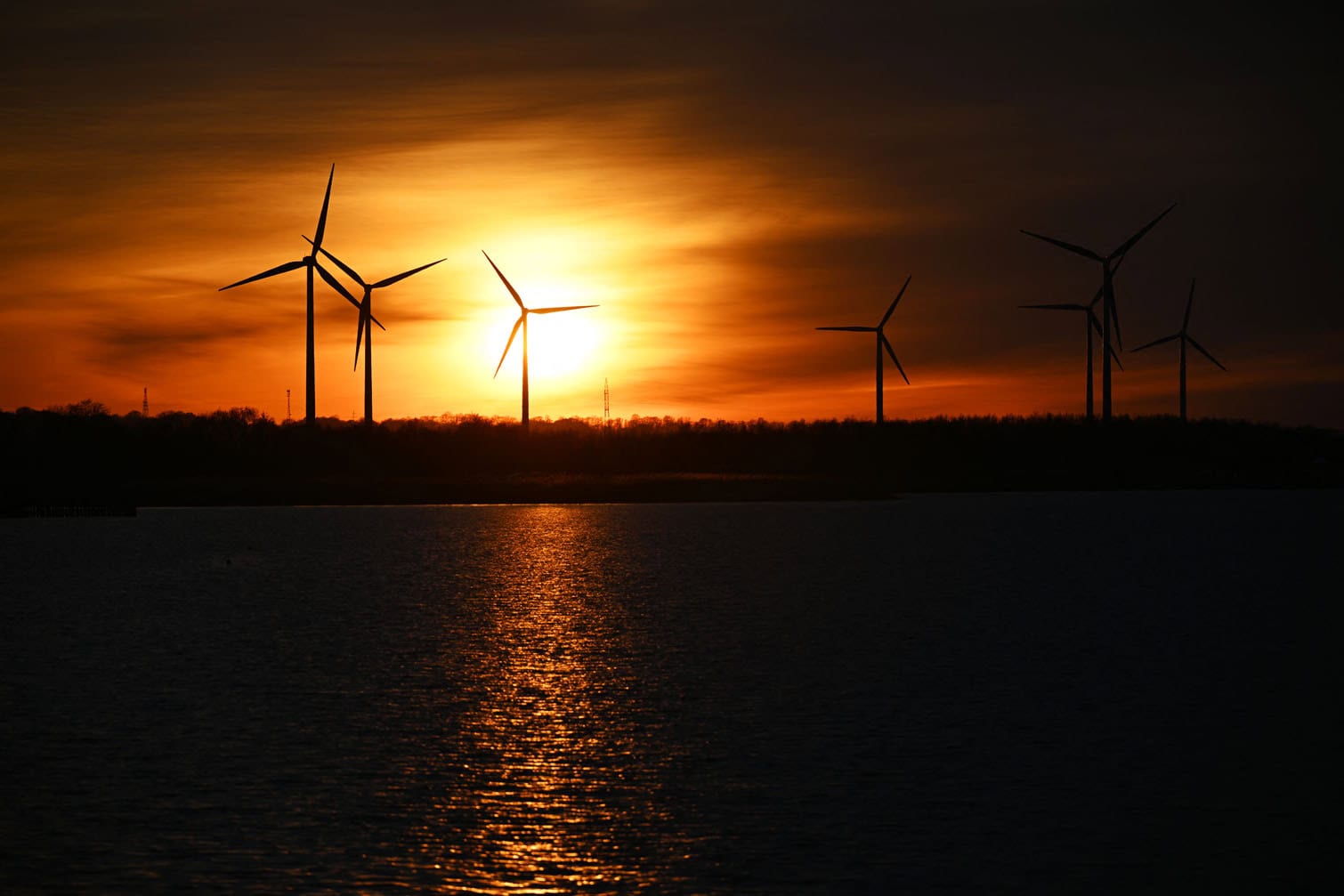 Wind turbines are seen at sunset