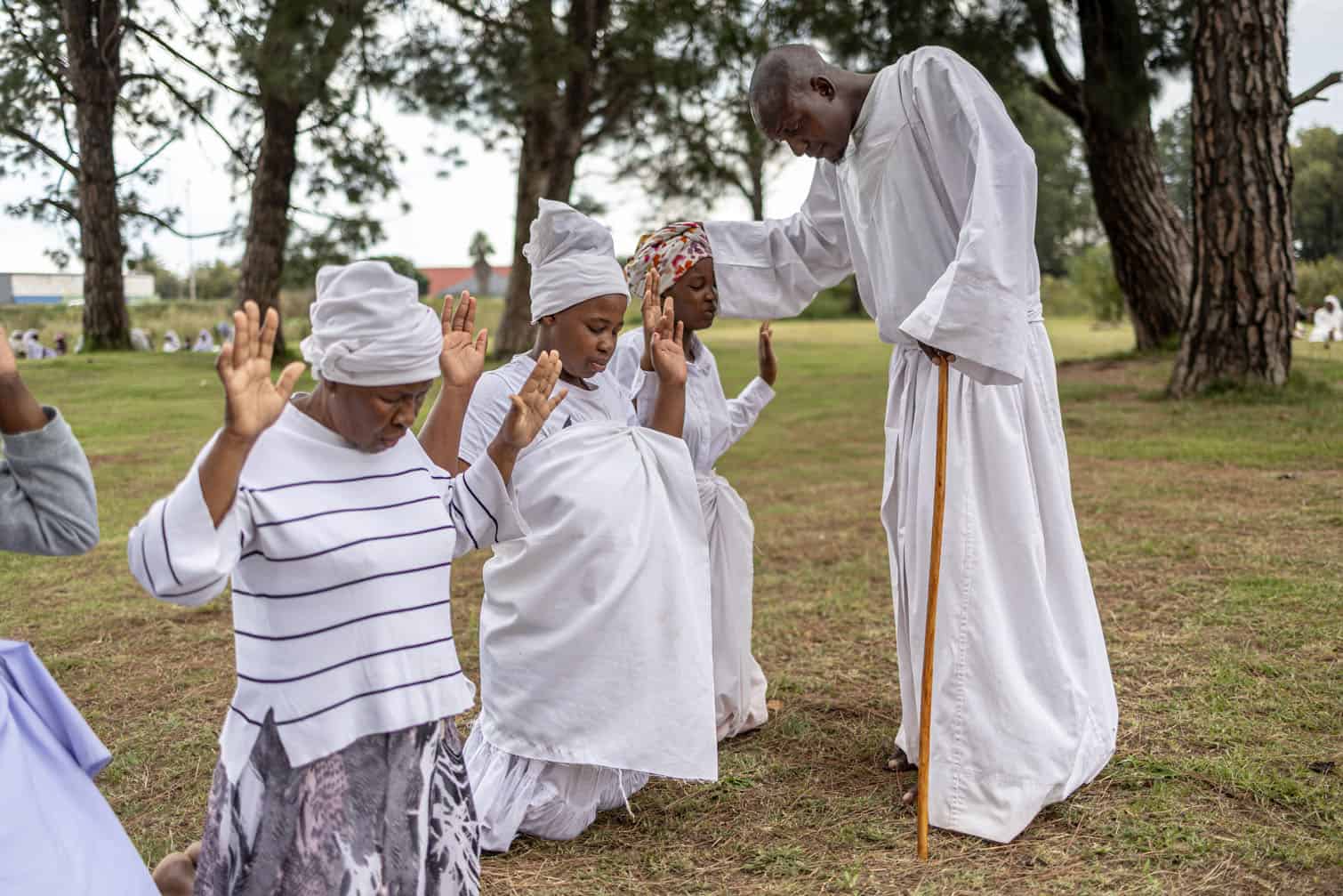 A religious leader prays for congregants