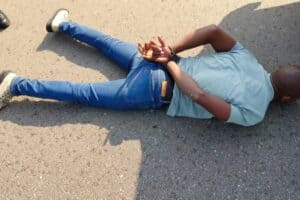 The suspect lies on the floor.