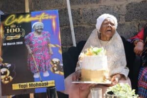 Topi Mohoasi holding her birthday cake.