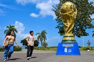 People walk past a giant replica of the FIFA World Cup trophy at the Cinta Costera in Panama City on 13 May 2026. Picture: Martin Bernetti / AFP