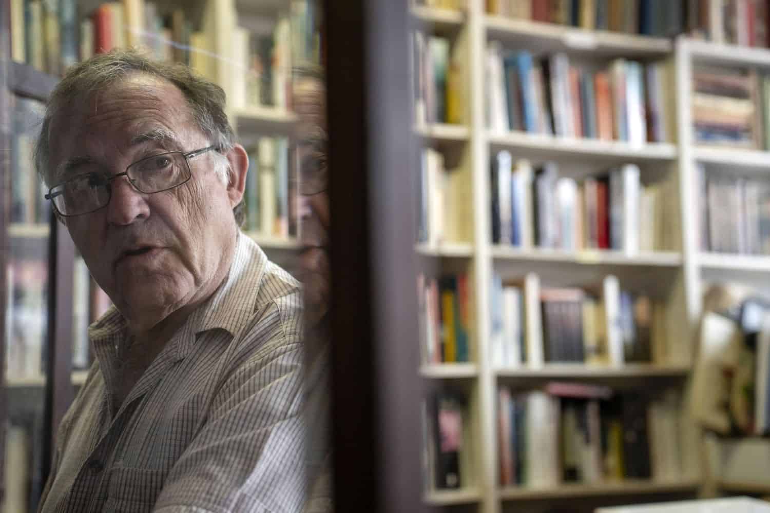 Doron Locketz, owner of Bookdealers of Melville, packing shelves on 8 April 2026. Picture: OUR CITY NEWS/Ihsaan Haffejee