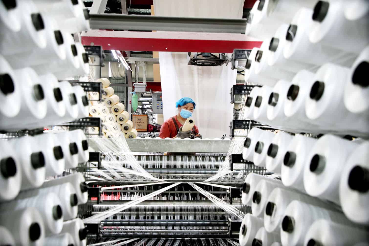 A worker monitors products for export