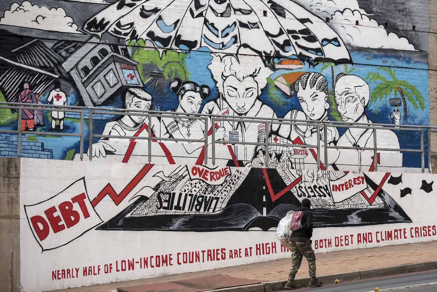 A pedestrian walks past a mural along Joubert Street at Constitution Hill