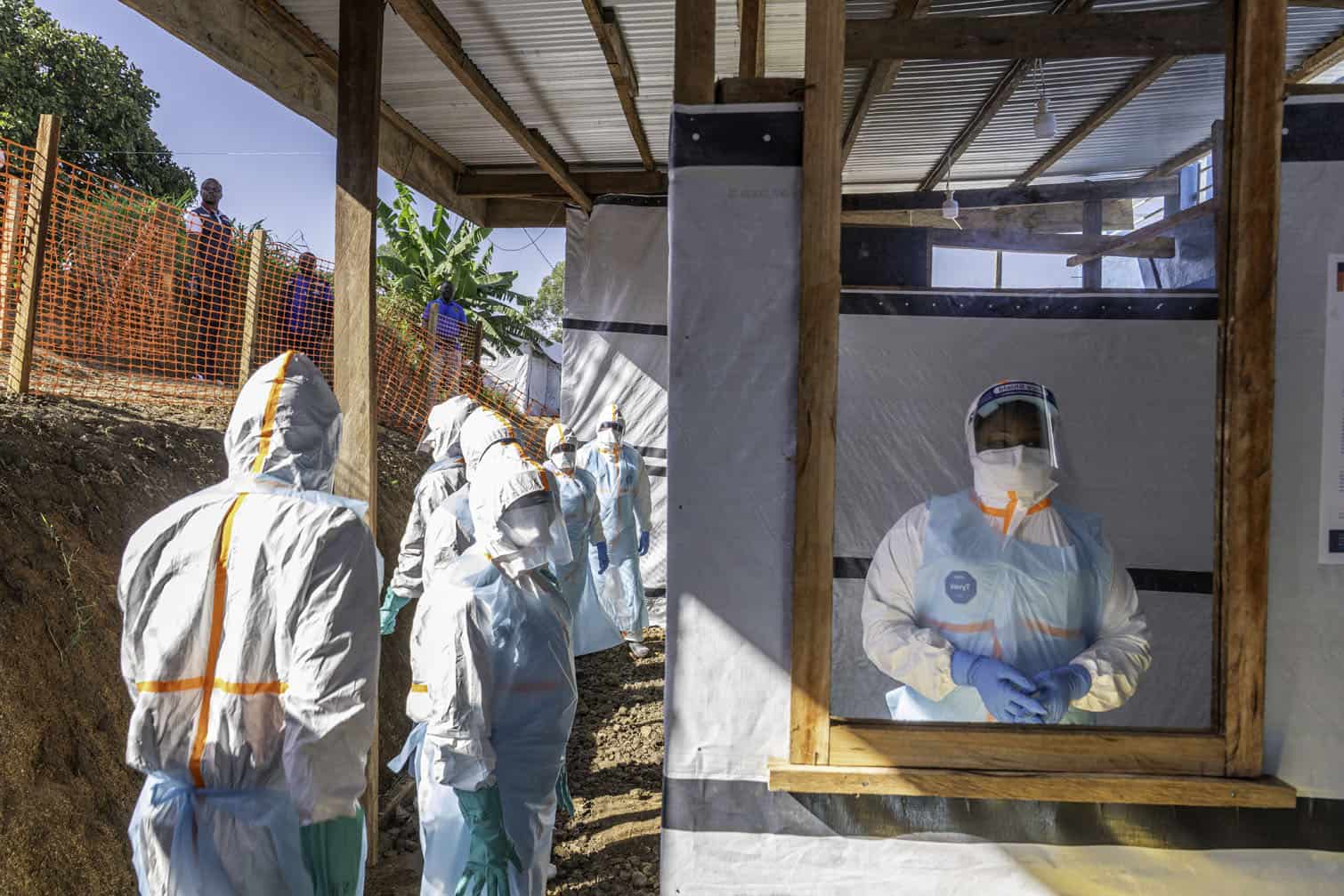 Health workers stand in a new Ebola treatment center