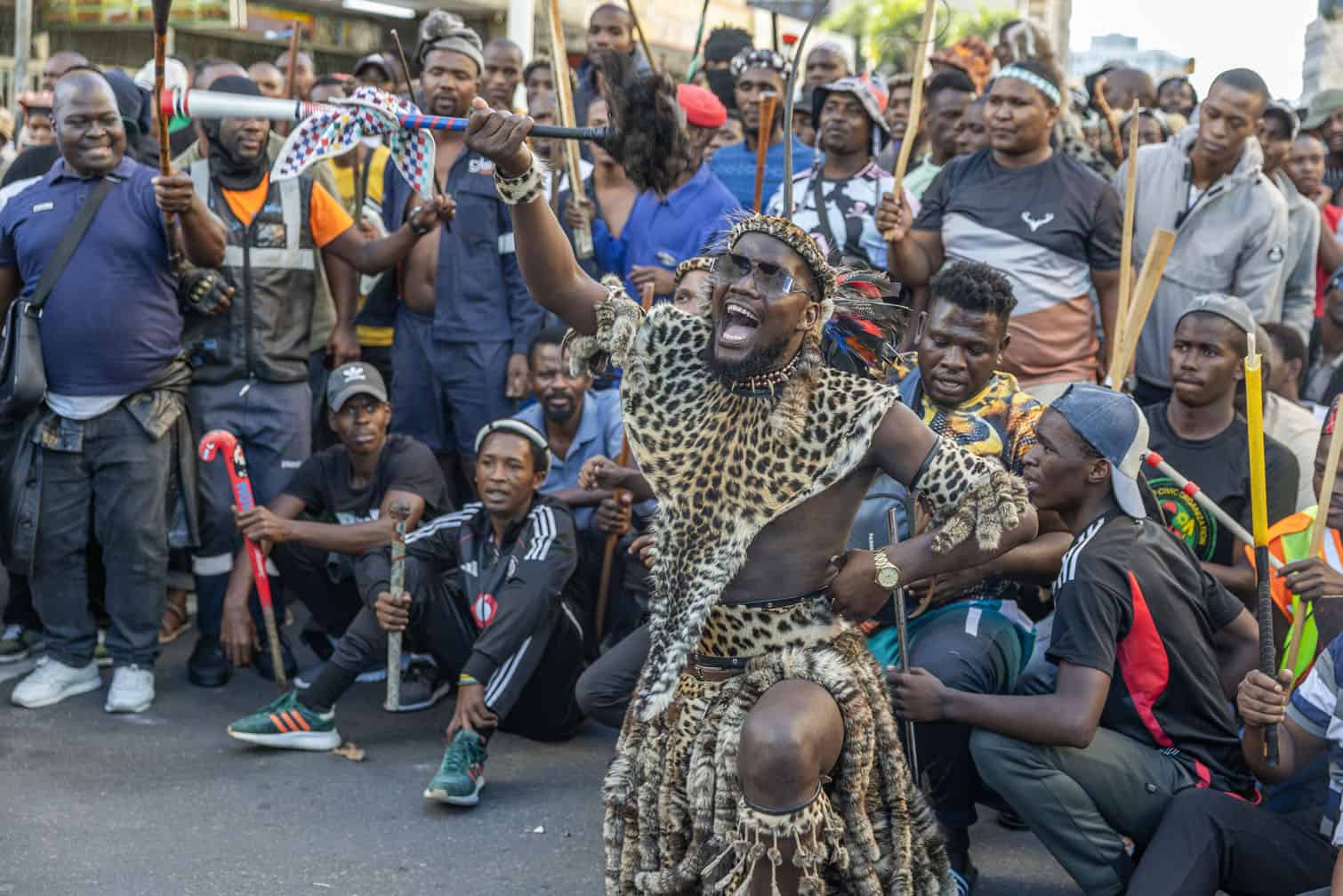 A protester dressed in traditional attire gestures during a protest march