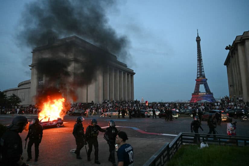 A car is set ablaze as PSG supporters celebrate
