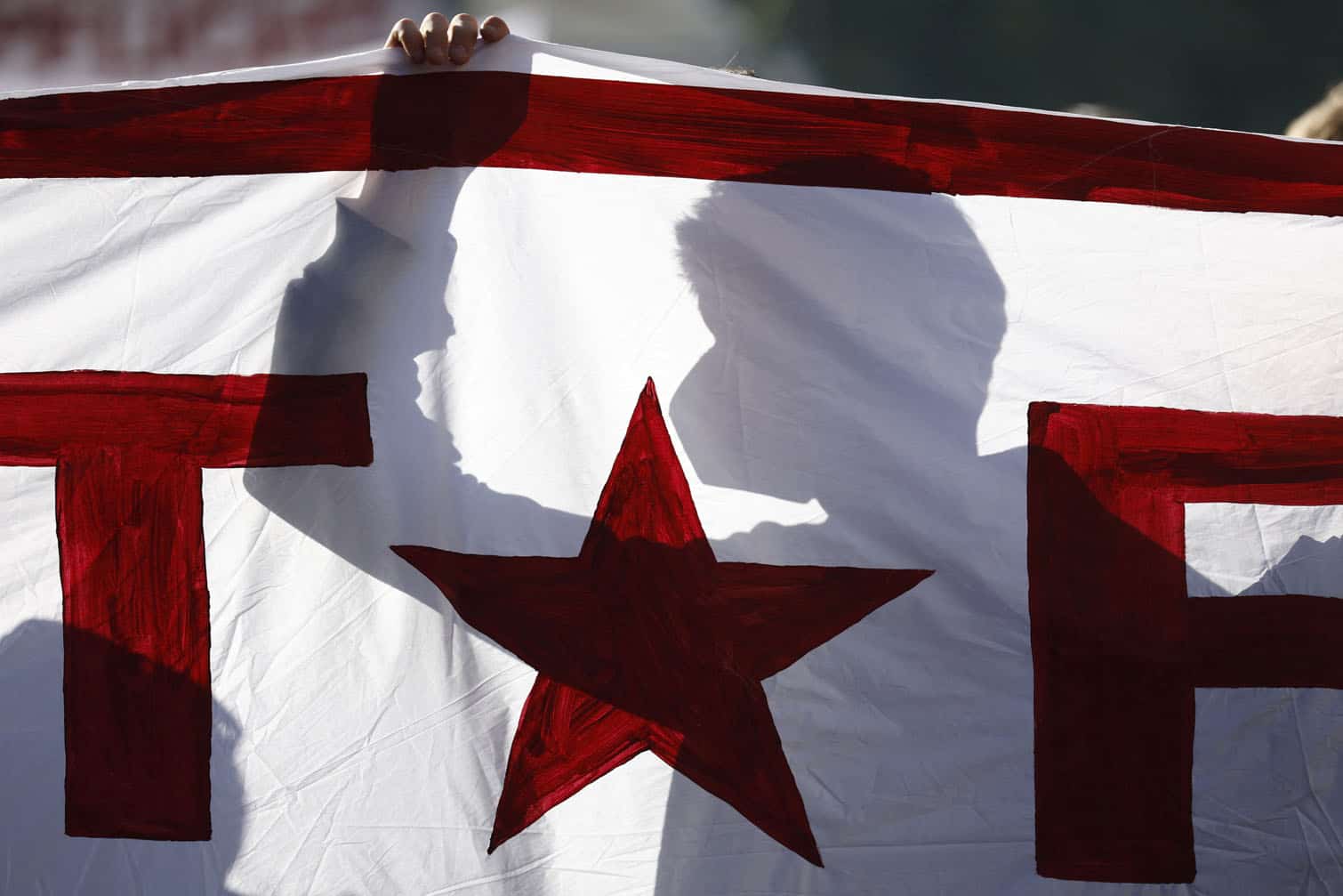 The shadow of a participant is seen behind a banner
