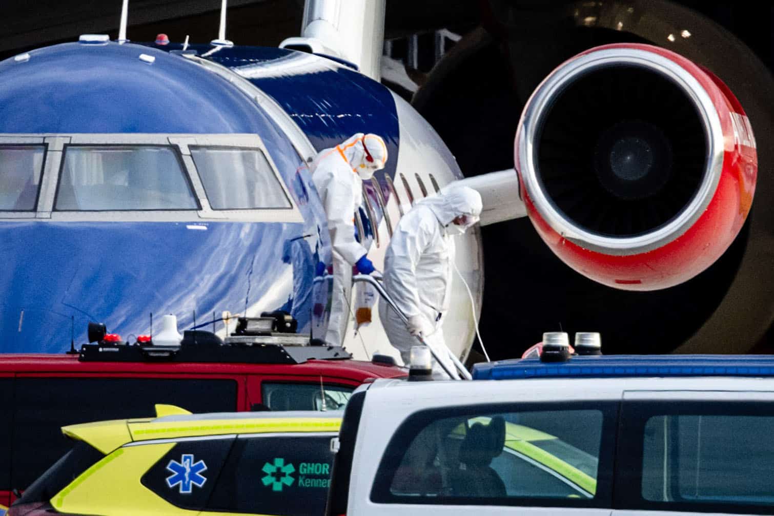 two people in hazmat suits