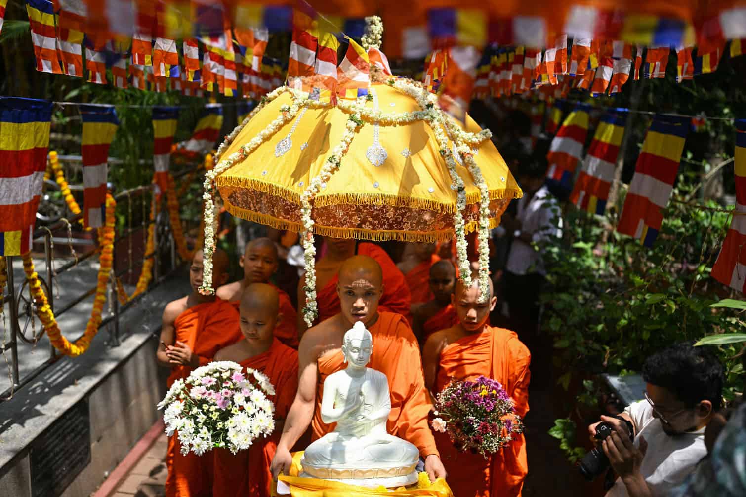 Buddhist monks carry an idol