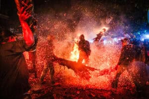 Participants strike each other with lit torches