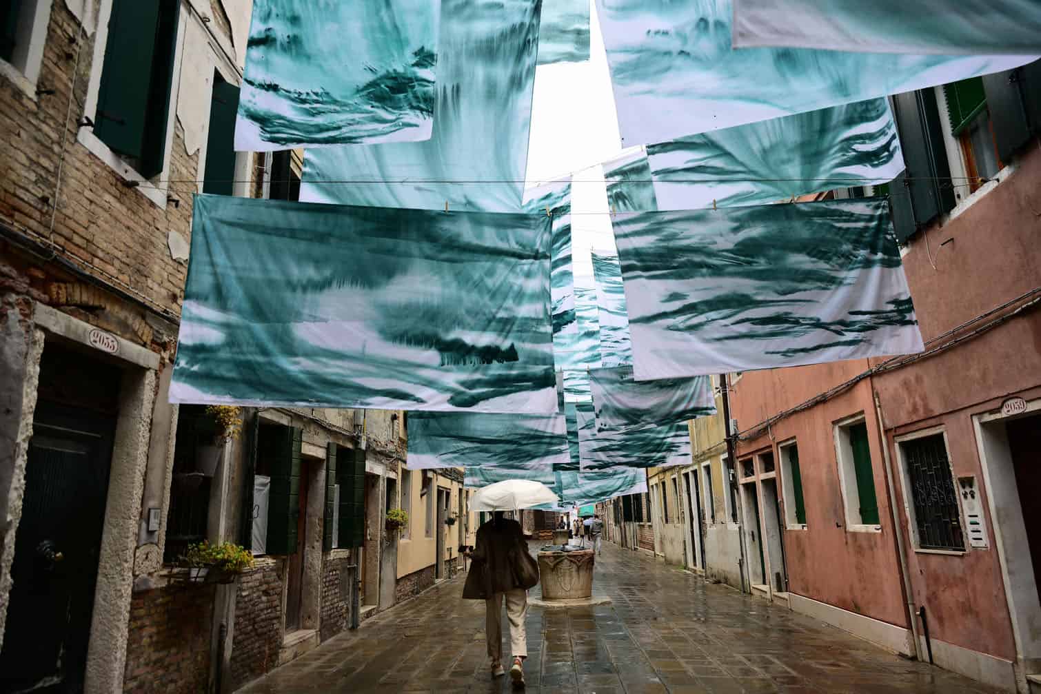 A pedestrian walks under an installation
