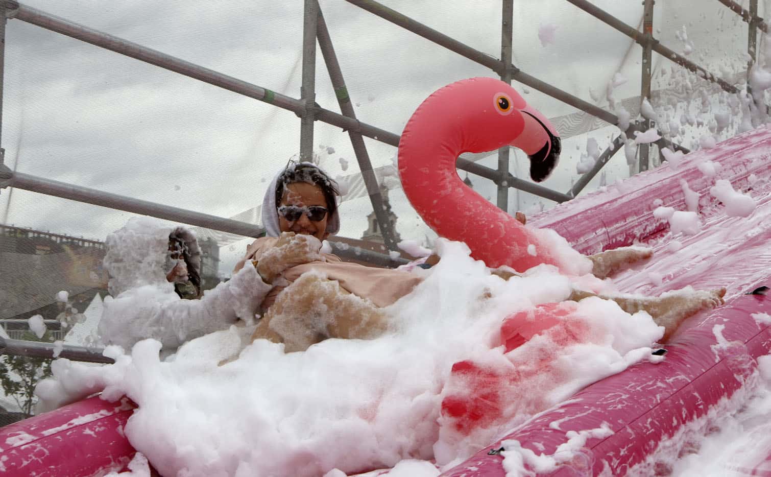People take part in the Saltibarsciai Slip and Slide competition