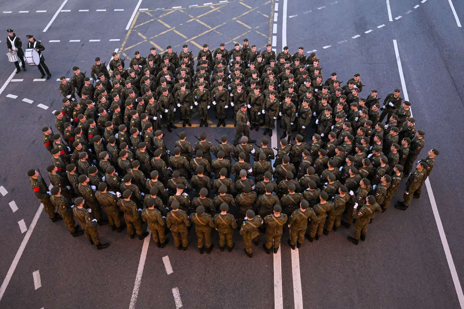 Russian servicemen await the rehearsal of the Victory Day military parade
