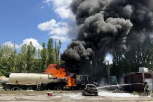 Ukrainian rescuers work to extinguish a fire