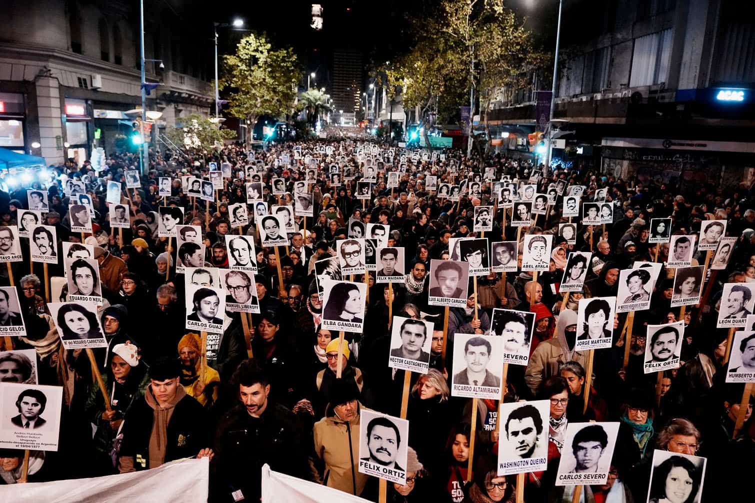 people holding portraits of those who disappeared