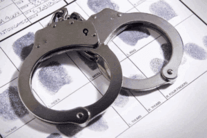 Police charge suspect filmed senselessly beating an elderly woman in tavern