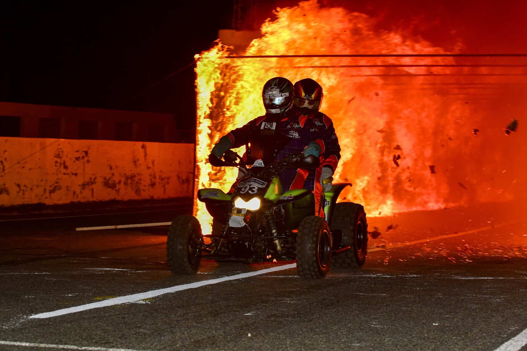 A quad bike exiting a fire tunnel