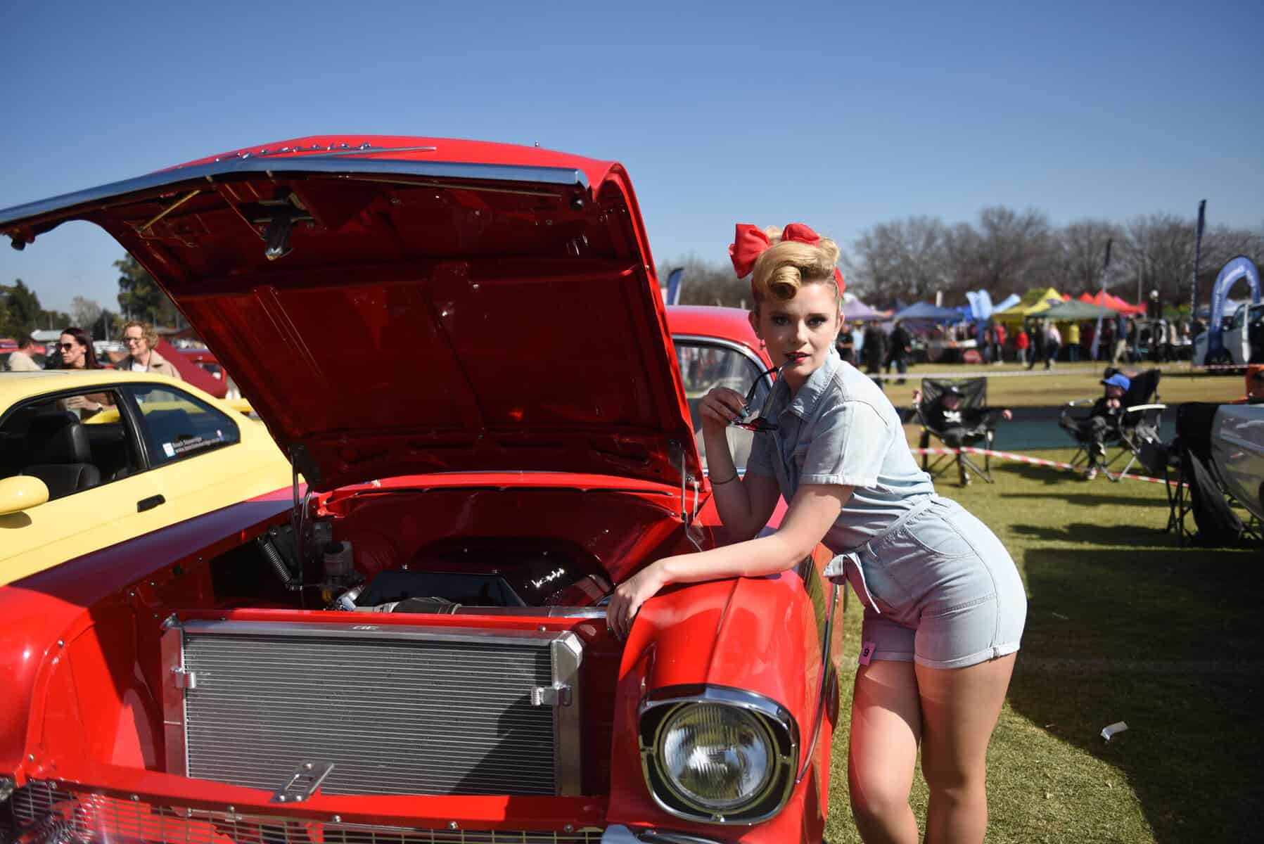 Marishe Vermeulen pose for a picture next to 1934 Ford Coupe