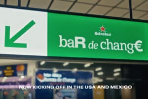Heineken bar de change sign at airport with currency exchange services.