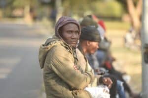 Man sits outside Malawian consulate in Johannesburg.