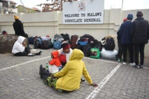Two women in conversation outside the Malawian consulate