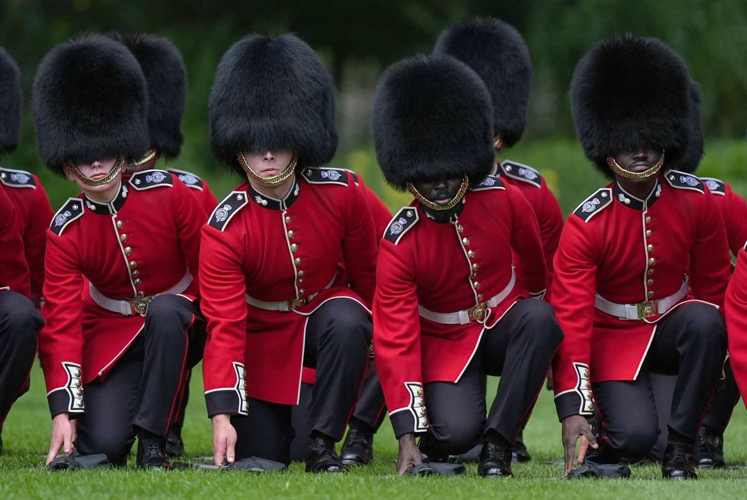 Members of the 1st Battalion Grenadier lower their rifles