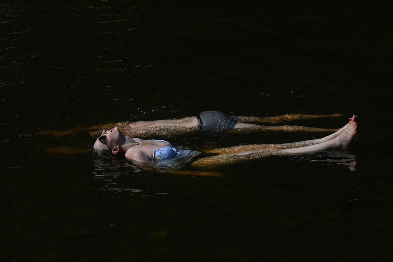 People bathe in the Vltava River