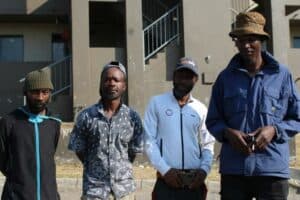 Luthando Mthana, Ntsieni Nemakwarani, Sisa James and Patrick Gaeadingwe raise concerns about living conditions at Fleurhof Hostel.