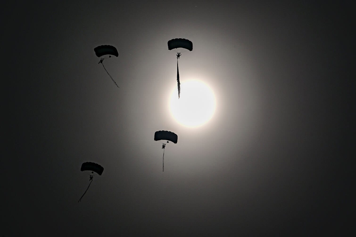 A group of parachuters descends