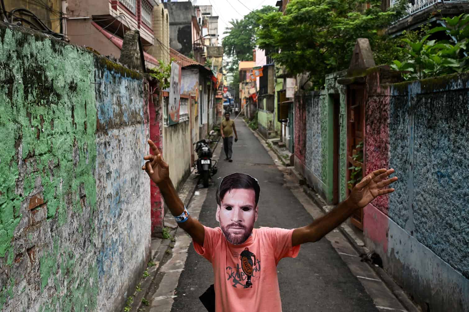 A fan wearing a mask of Argentina's footballer Lionel Messi