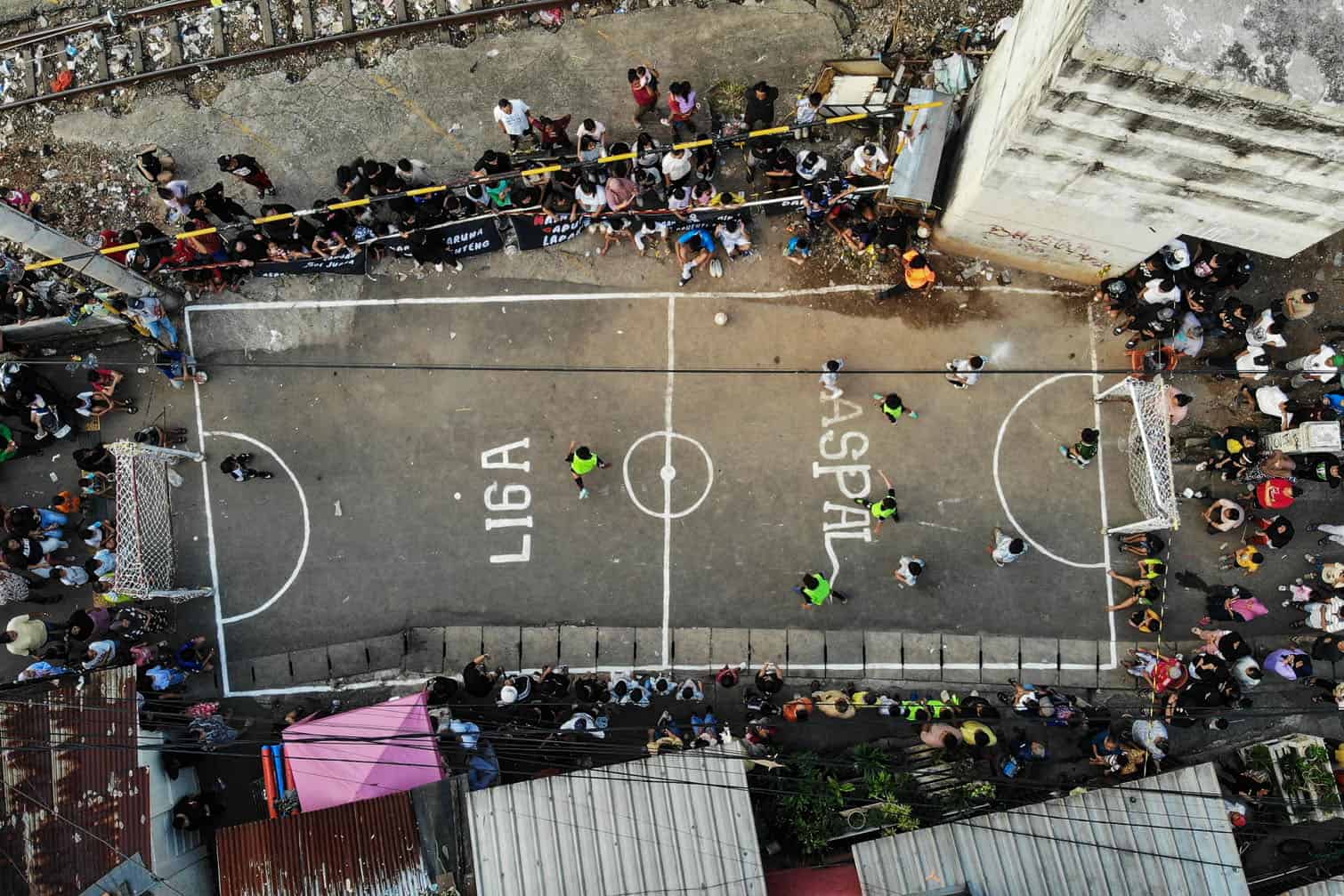 children competing in a street football tournament