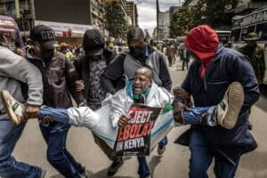 An activist shouts slogans while being arrested by plainclothed Kenyan police