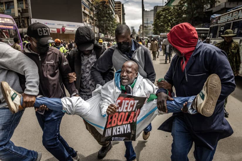 An activist shouts slogans while being arrested by plainclothed Kenyan police