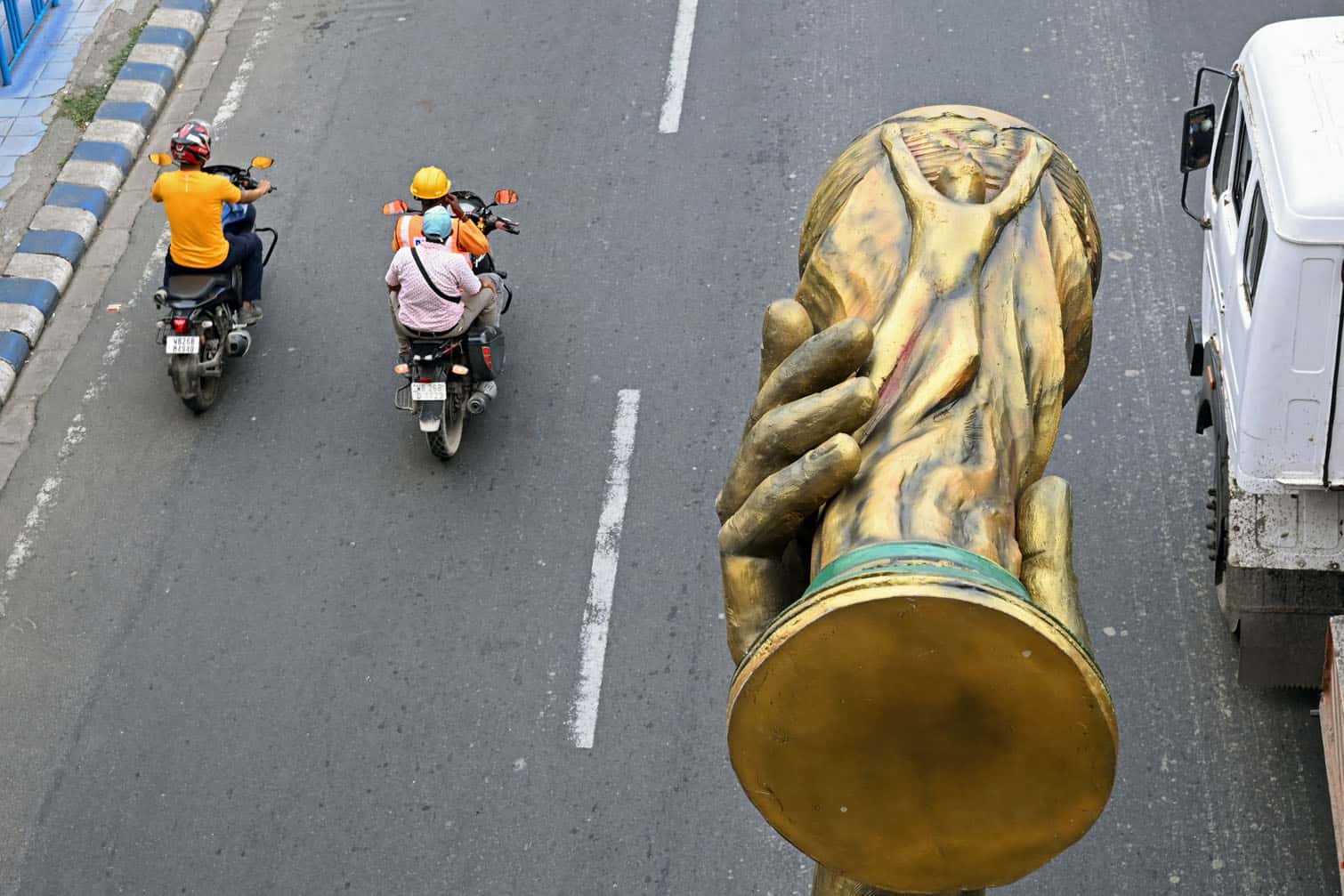 Workers transport a statue of Argentine football player Lionel Messi